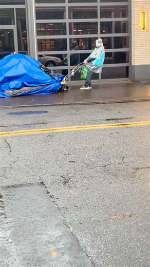 The Streets on Instagram: "A Mobile Homeless Camp A homeless man has come up with a remarkably clever way to stay ahead of city sweeps. Beneath his tent is a wooden pallet, and underneath that, a lawnmower. When the city posts notice that the camp must be cleared, he simply pulls his entire setup about a block away. Because he has technically moved from the original location, the city must start the process over—post a new notice and wait another three days before enforcing a sweep. For him, the