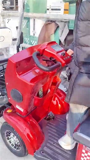 Nearby, there are four-wheeled covered minibuses (E900) for transportation