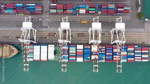 commercial dock and container ship load and unloading by crane for distribution import and export international, business and industrial Transportation worldwide, aerial top view from drone 4k video,
