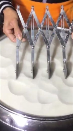 A cutting tool that is being used to cut food dough with a neat result