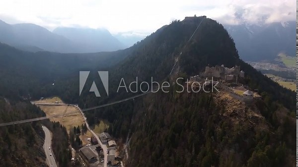 Luftbildaufnahme of Highline179 in Austrian Alps. This high-altitude suspension bridge links two fortress sites and offers breathtaking views, history and adventure in Tyrol. Burg Ehrenberg in Reutte