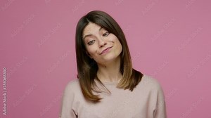 Closeup dumb woman making silly face with eyes crossed, fooling around with idiotic laughter, showing stupid brainless humorous facial expression. indoor studio shot isolated on pink background