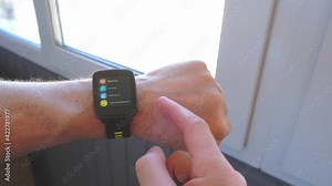 Smart technologies. A person adjusts the settings of a sports watch for outdoor training
