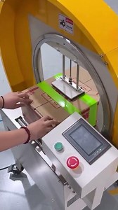 the process of installing green duct tape on packing cardboard using an automatic machine advanced.
