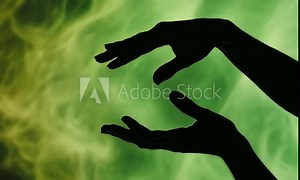 Silhouette of human hands reaching towards each other against green backdrop