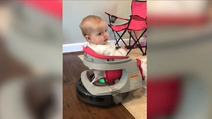 Dad lets baby ride on top of robot hoover