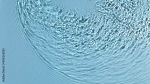 Water banner background. Blue aqua texture, surface of ripples, rings, transparen and sunlight. Spa concept background. Flat lay, top view, copy space