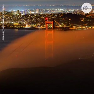 Golden Gate Bridge glows behind foggy San Francisco bay