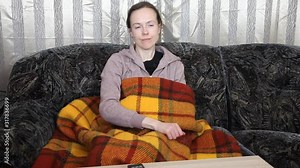 Woman is turning on TV set with TV remote, watching TV and falling asleep, dropping TV remote .