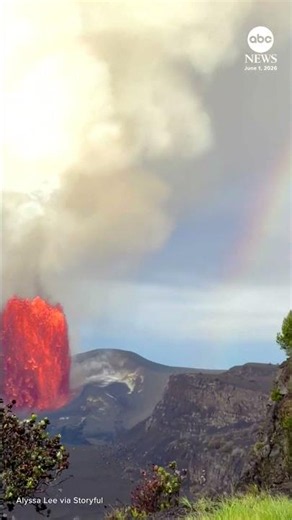 Erupting volcano and rainbow share sky in Hawaii