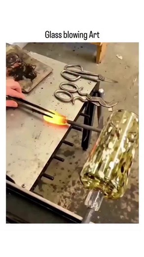 CODED on Instagram: "The video showcases a mesmerizing glassblowing demonstration in a studio setting, where artisans gather molten glass at over 1,400°C, shape it on blowpipes using tools like jacks and shears, and create vibrant, swirling-patterned vases and platters through techniques like free-blowing and color layering. Posted by @interesting_aIl , an account focused on captivating art and history content, the clip has quickly garnered 166,000 views and 600+ likes within hours, with replies