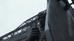 A soldier in ammunition transmits information via walkie-talkie