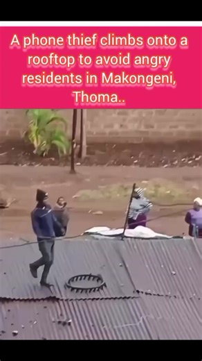 A phone thief climbs onto a rooftop to avoid angry residents in Makongeni, Thoma.. | Kenya Waves