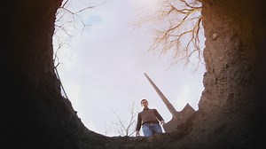 Person filling a hole in the ground - Free Stock Video