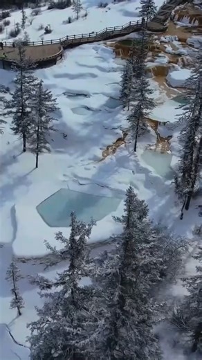 A spring snowfall has glowed white on the mountains of the Huanglong Scenic Area in southwest China’s Sichuan Province. The sun shines through the clouds and casts light on these mountains, turning the entire area into a fairy-tale world. Under the sunlight, the colorful pools resemble a set of emeralds or a huge palette, shimmering with vibrant colors. #snowday #mountains #sichuan #huanglong #dronephotography #chinacharm | CGTN China24