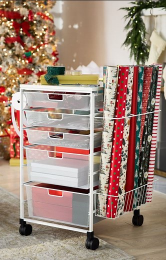 Wrap your gifts in style and ease with the customer-favorite Elfa Gift Wrap Cart! 🎁💙 SHOP online: https://container.store/3VwkwuV The Elfa Gift Wrap cart has drawers for small items, gift wrap storage, a ribbon holder, and it’s on wheels, making it easy to wrap anywhere in your house! See below the features and benefits. 🎁 It’s not only great for the holiday season, but all year round! 🎁 The top provides the perfect work surface. 🎁 Epoxy-bonded steel construction and exceptionally smooth-gl