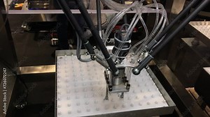 An AI-powered robotic packaging machine is demonstrating its functionality in public view.