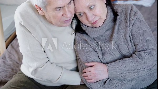 Senior couple hugging each other, kissing at home bedroom. Intimate Moment. Tender embrace between elderly age man and woman, husband and wife. Old people deep love. Time and feelings. Loving family