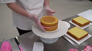 Easily create and decorate an elegant heart shaped cake for your Valentine’s Day cake case. | DecoPac