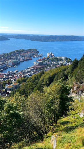 19 reactions · 11 shares | Fløyen Funicular & City View: Sunny Day in Bergen, Norway  Enjoy a breathtaking panorama from Mount Fløyen in Bergen, Norway! On this rare sunny day, watch the Fløibanen funicular descend while the city unfolds below — colorful houses, the sparkling fjord, and the mountains surrounding Bergen. Yes, the sun really does shine in Bergen, and the views are simply unforgettable! | CrazyTroll - Nordic Stories | Facebook