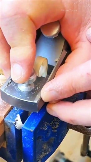 smoothly planing the surface of a solid wooden block using a traditional manual hand tool at home
