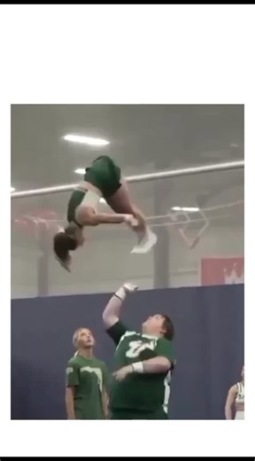 @meme.vide_.1 on Instagram: "The post showcases a video of a plus-sized male university cheerleader flawlessly lifting and tossing female teammates during stunts, highlighting extraordinary strength, balance, and trust in a green-uniformed team routine on a gym mat. Authored by a Japanese "confusion bot" account that shares daily perplexing content, the caption "His campus life seems fulfilling" playfully contrasts the athletic feat with everyday student vibes, driving 26,000 likes and 5 million