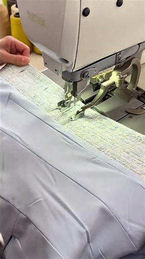 Sewing the edges of two different fabrics with a professional machine for high quality dressmaking