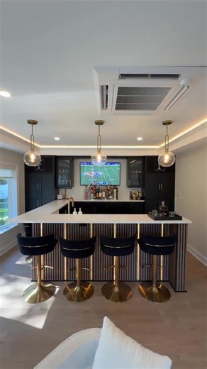 Where modern design meets classic comfort! 😍 This transitional basement features a soothing light palette, tactile fabrics, with a understated elegance! Let us know your favorite feature in the comments.👇 • • #finishedbasement #designinspo #centralnewjersey #newjersey #bridgewaternj #transitional #moderndesign #hgtv #bar #hiddendoor #laundryroom | Finished Basements NJ