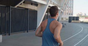 Rear Back View of Handsome Sport Man Running Outdoors