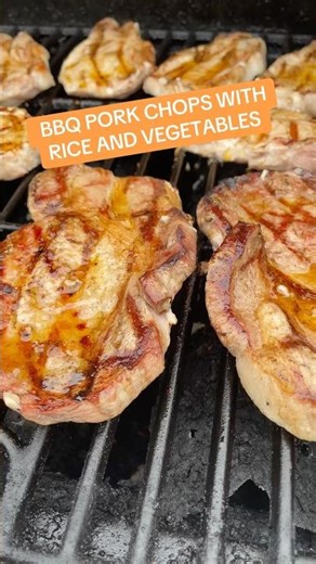 Barbeque pork chops with rice and mixed vegetables.