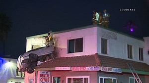 A speeding car was left dangling off the second floor of a building in Santa Ana after it hit a median and went airborne. http://4.nbcla.com/mVlURlB | NBC LA