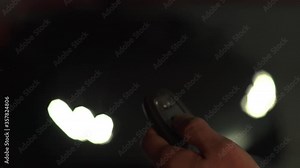 Close-Up Of Man's Finger Pressing Car Key. Man Unlocks Luxury Car With Smart Key In A Garage. Concept Of Luxury, Transportation And Action