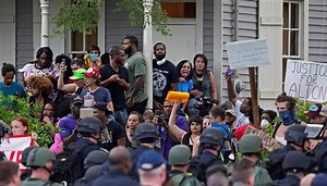 SWAT teams broke up a protest in the front yard of a house in Baton Rouge, despite the homeowner asking them not to http://nbcnews.to/29r0JIk | NBC News