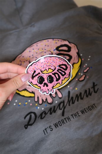 Today marks the start of our monthly Sticker Series! On the 13th of each month, we’re dropping a brand new LIMITED EDITION sticker! 🫶 Once a sticker sells out, it won’t be made again 😈 They are FREE with any purchase online only on the 13th of the month, while supplies last. They can also be purchased on their own on release day online or at participating Voodoo Doughnut locations. If inventory remains after release day, they will stay for sale until sold out! Get yours before they’re gone 💖 