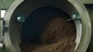 Closeup of an industrial composting machine efficiently turning food waste into organic fertilizer reducing the factorys overall ecological footprint..