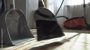 Cleaning.Clean up the garbage from the floor with a broom for cleanliness.Sweep away dust and dirt with a brush into a dustpan.Sweeping the carpet with a broom at home.Indoor cleaning tools.