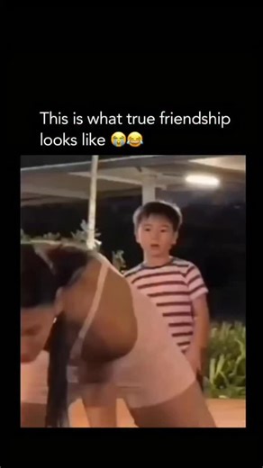 MemeDrop.Daily on Instagram: "He wasn't gonna let his bro miss that The video captures a humorous and relatable moment at an outdoor park or gym area. A woman is performing an impressive, high-intensity calisthenics move-a straddle planche-using parallette bars. As she extends her legs outward, a young boy standing nearby is caught completely off guard, his mouth hanging open in pure amazement at her strength and flexibility. The "true friendship" element mentioned in the caption comes into play