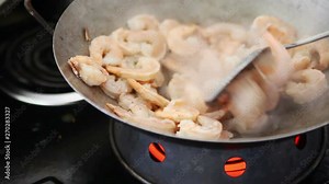 Using the stir fry method of cooking shellfish