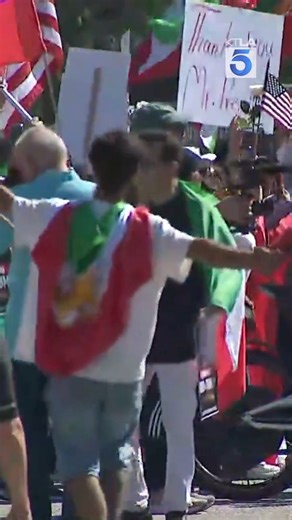 Law enforcement closed off roads in Westwood Sunday afternoon as a large crowd gathered to celebrate the U.S. and Israeli military strikes that killed Iran’s Supreme Leader Ayatollah Ali Khamenei. For Full Story: https://ktla.com/news/local-news/thousands-gather-near-westwood-federal-building-for-iran-protests-roads-closed/ | KTLA 5 News