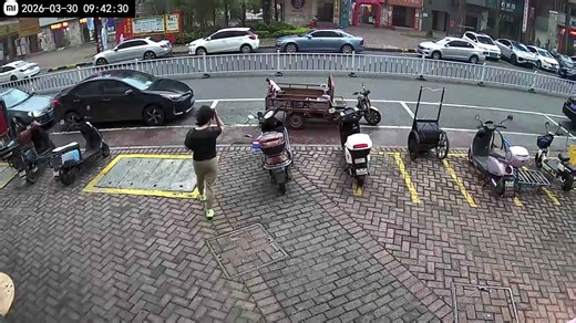 Woman stops tricycle pushed by strong winds in Guangdong, China