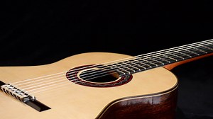 Download Classic guitar rotating at black background for free