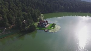 Aerial view of a house by the lake - Free Stock Video