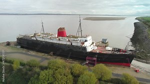 Decaying rusty TSS Duke of Lancaster ship, aerial fly forward view