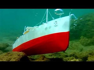 Sinking cardboard ships and submarine models, underwater footage