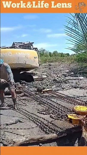 A team uses block and tackle systems to pull an excavator from deep mud, multiplying force.