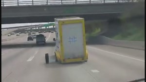 VIDEO: Wheel on trailer detaches, crashes into Highway 59 concrete barrier