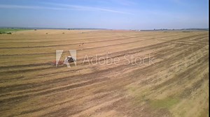 Tractor working on the field cultivating soil in Ukraine