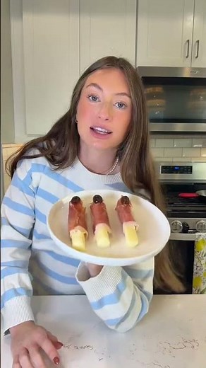 Wrap prosciutto around cheese sticks, cut pitted olives in half