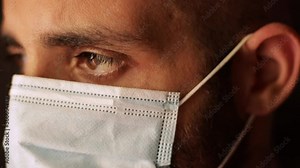 Hope concept: Masked doctor is tired about coronavirus, closing eyes. Prevention and pandemic period, caucasian masked man estreme close up portrait