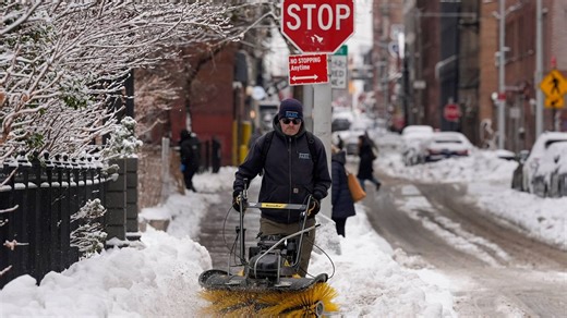 More snow falls on the Northeast, where huge piles remain from the last storm